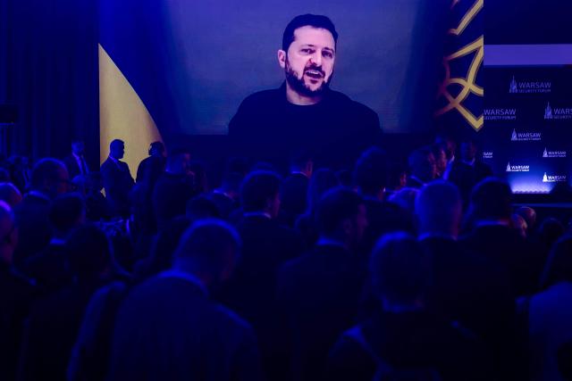 Participants listen as Ukraine's President Volodymyr Zelensky speaks via videolink during the opening session of the Warsaw Security Forum in Warsaw, Poland on October 12, 2026. (Photo by Wojtek RADWANSKI / AFP)
