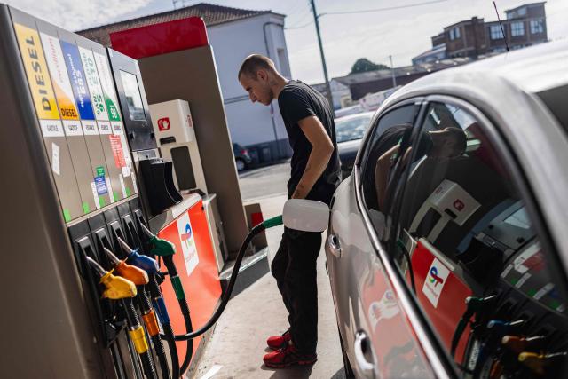 (FILES) A motorist fills his car at a Total Energies petrol station in Faches-Thumesnil near Lille, northern France on August 10, 2023. TotalEnergies commits to lowering the price of a liter of off-road diesel by 20 cents according to CEO of TotalEnergies Patrick Pouyanne. (Photo by Sameer Al-DOUMY / AFP)
