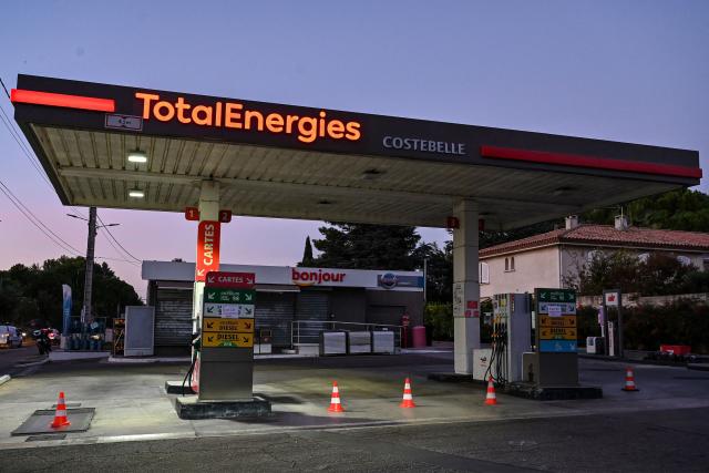 (FILES) Signs which read in French as "out of service" are seen at a closed TotalEnergies petrol station in Montpellier, southern France, on October 4, 2022. TotalEnergies commits to lowering the price of a liter of off-road diesel by 20 cents according to CEO of TotalEnergies Patrick Pouyanne. (Photo by Pascal GUYOT / AFP)