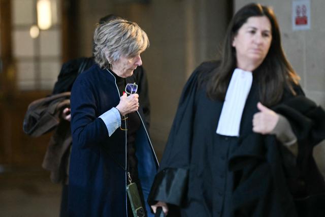 Celebrity press agent Mimi Marchand (L) arrives with her French lawyer, Caroline Toby, at the Paris courthouse for the appeal hearing in her case involving the alleged extortion of French television presenter Karine Le Marchand, in Paris, on October 12, 2026. (Photo by LOU BENOIST / AFP)