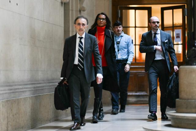 French television presenter Karine Le Marchand (2L) arrives with her legal team at the Paris courthouse to attend a hearing in the appeal trial of celebrity press agent Mimi Marchand, , who is appealing her conviction for extortion against Le Marchand, in Paris, on October 12, 2026. (Photo by LOU BENOIST / AFP)
