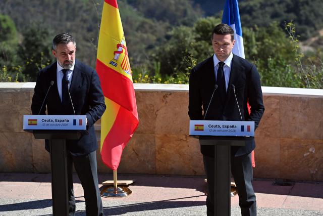 Leader of Spanish far-right party Vox Santiago Abascal (L) and President of French far-right party Rassemblement National (RN) Jordan Bardella give a joint press conference in Spain's North African enclave of Ceuta on October 12, 2026 amid migration crisis. The Spanish North African enclave of some 80,000 inhabitants seek to regain balance while hundreds of migrants remain in makeshifts camp after the massive influx of tens of thousands of migrants from Morocco in late July. (Photo by Antonio Sempere / AFP)
