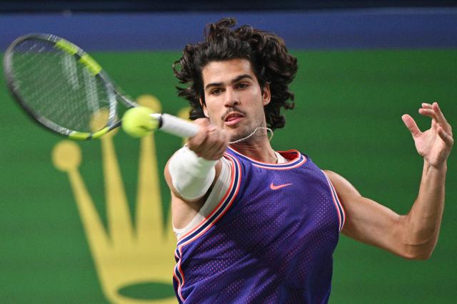Spain's Carlos Alcaraz hits a return to Belgium's Zizou Bergs during their men's singles match at the Shanghai Masters tennis tournament in Shanghai on October 12, 2026. (Photo by Hector RETAMAL / AFP)