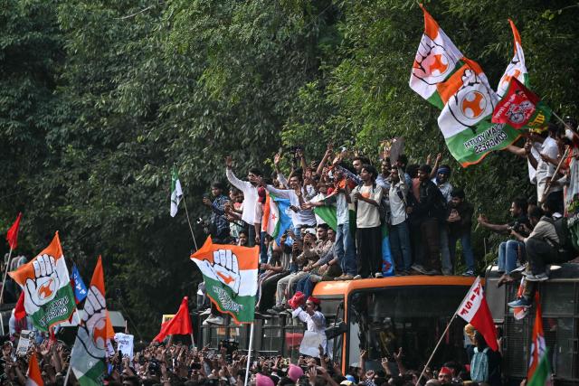 India's opposition Congress party supporters shout slogans from atop a bus during a protest demanding the resignation of the country's Chief Election Commissioner Gyanesh Kumar over alleged voter roll irregularities linked to the "special intensive revision" (SIR), in New Delhi on October 12, 2026. Authorities deployed thousands of personnel across central Delhi for a third straight day on October 12, erecting heavy metal barricades and closing key metro stations before a march called by opposition leader Rahul Gandhi. (Photo by Sajjad HUSSAIN / AFP)