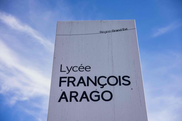 This photograph taken on October 12, 2026, shows a sign bearing the name of the Francois Arago high school, where students carried out a blocking protest in Reims, northeastern France. In Reims, two members of the reception staff at Franзois Arago high school were injured by fireworks mortar rounds, according to multiple sources. “At least eight education staff members” were injured on the morning of October 12, 2026, amid protests by the high school student movement, the ministry said, noting that this figure did not include the middle school principal and the teacher injured by a shotgun blast in Aubagne. (Photo by Sameer Al-DOUMY / AFP)