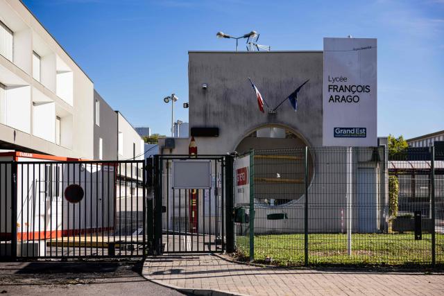 This photograph taken on October 12, 2026, shows the entrance of the Francois Arago high school, where students carried out a blocking protest in Reims, northeastern France. In Reims, two members of the reception staff at Franзois Arago high school were injured by fireworks mortar rounds, according to multiple sources. “At least eight education staff members” were injured on the morning of October 12, 2026, amid protests by the high school student movement, the ministry said, noting that this figure did not include the middle school principal and the teacher injured by a shotgun blast in Aubagne. (Photo by Sameer Al-DOUMY / AFP)