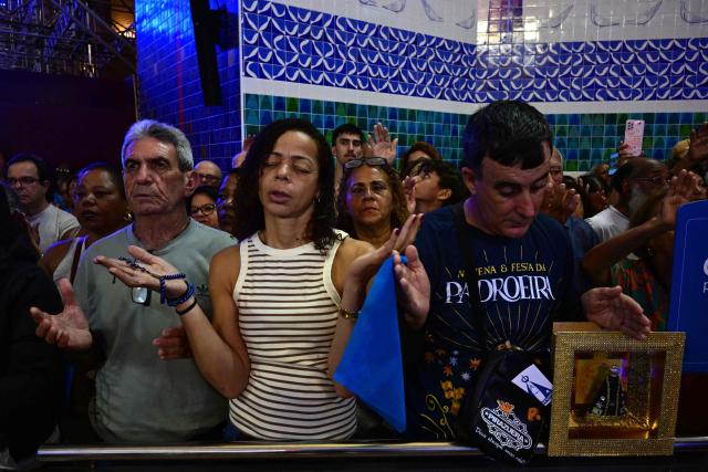 Catholic devotees attend celebrations marking Our Lady of Aparecida Day at the Basilica of the National Shrine of Our Lady of Aparecida, Brazil's patron saint, in Aparecida, Sao Paulo state, Brazil, on October 12, 2026. (Photo by Pablo PORCIUNCULA / AFP)