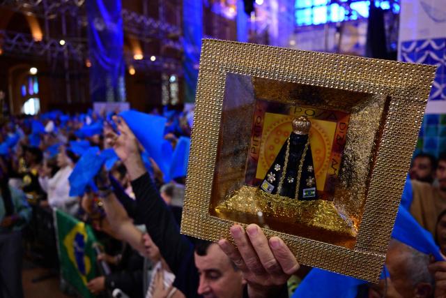 Catholic devotees attend celebrations marking Our Lady of Aparecida Day at the Basilica of the National Shrine of Our Lady of Aparecida, Brazil's patron saint, in Aparecida, Sao Paulo state, Brazil, on October 12, 2026. (Photo by Pablo PORCIUNCULA / AFP)