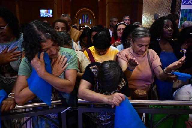 Catholic devotees attend celebrations marking Our Lady of Aparecida Day at the Basilica of the National Shrine of Our Lady of Aparecida, Brazil's patron saint, in Aparecida, Sao Paulo state, Brazil, on October 12, 2026. (Photo by Pablo PORCIUNCULA / AFP)