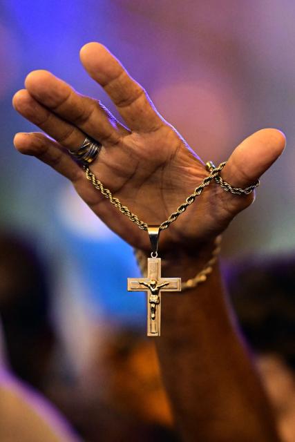 A Catholic devotee attends celebrations marking Our Lady of Aparecida Day at the Basilica of the National Shrine of Our Lady of Aparecida, Brazil's patron saint, in Aparecida, Sao Paulo state, Brazil, on October 12, 2026. (Photo by Pablo PORCIUNCULA / AFP)