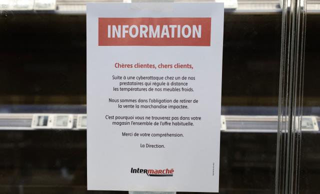 This photograph shows a customer notice displayed on empty fresh-food refrigerators at an Intermarche supermarket in Nevez, western France, on October 12, 2026, following a cyberattack affecting the French supermarket chains Intermarchй and Cooperative U that caused their refrigerators to defrost. Some 150 to 200 Intermarche stores were targeted in the attack on October 12, 2026, along with nearly 100 Coopйrative U outlets, the retailers said. BFM TV reported that rival giant E. Leclerc was also affected, with hackers “managing to remotely trigger the forced defrosting of refrigeration systems in numerous stores.” (Photo by Fred TANNEAU / AFP)