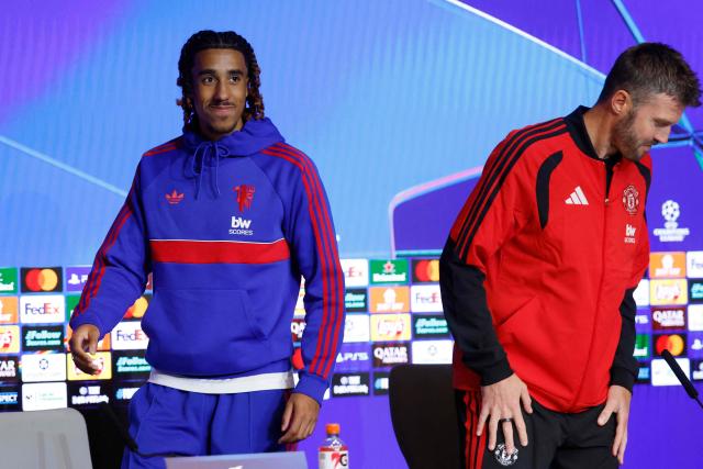 Manchester United's French defender #15 Leny Yoro (L) and Manchester United's English head coach Michael Carrick arrive to give a press conference on the eve of the UEFA Champions League, league phase matchday 2 football match between Club Atletico de Madrid and Manchester United at the Metropolitano stadium in Madrid on October 12, 2026. (Photo by Oscar DEL POZO / AFP)