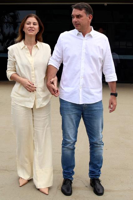 Brazil's right-wing Senator and presidential candidate for the Liberal Party (PL) Flavio Bolsonaro and his wife Fernanda Bolsonaro arrives for a mass marking the celebration of Brazil's patron saint, Our Lady of Aparecida, at the Metropolitan Cathedral of Brasilia in Brasilia, Brazil, on October 12, 2026. (Photo by Sergio Lima / AFP)
