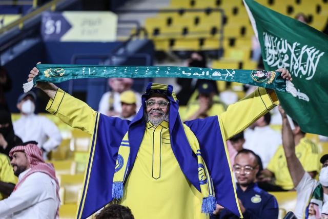 A supporter of Al-Nassr cheers for his team prior to the AFC Champions League group B football match between Al-Nassr and Neftchi Fergana at Alawwal Park stadium in Riyadh on October 12, 2026. (Photo by Fayez NURELDINE / AFP)