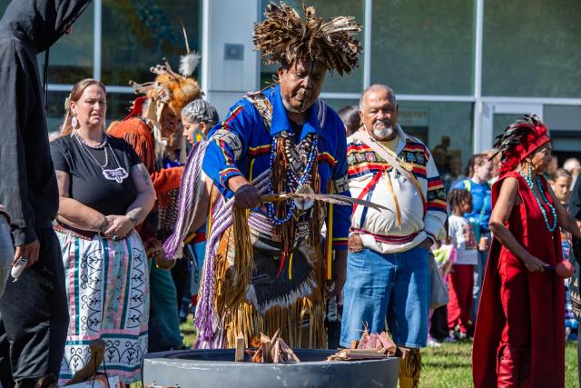 Anthony Dean Stanton, Chief Sachem of the Narragansett Indian Tribe, fans a fire during the opening ceremony at an Indigenous People's Day event in Newton, Massachusetts, October 12, 2026. (Photo by JOSEPH PREZIOSO / AFP)