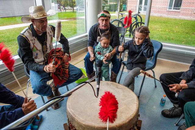 Drummers play as people take part in a community dance during an Indigenous People's Day event in Newton, Massachusetts, October 12, 2026. (Photo by JOSEPH PREZIOSO / AFP)