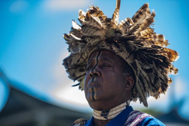 Anthony Dean Stanton, Chief Sachem of the Narragansett Indian Tribe, stands and looks to the sky during the opening ceremony during an Indigenous People's Day event in Newton, Massachusetts, October 12, 2026. (Photo by JOSEPH PREZIOSO / AFP)