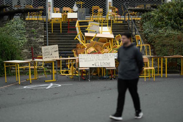 A student walks past the blocked entrance of a building of classrooms in the Rennes 2 university, on october 12, 2026. (Photo by Loic VENANCE / AFP)
