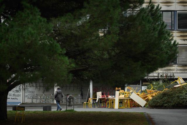 A man walks past the blocked entrance to a building at the University of Rennes 2, in Rennes on October 12, 2026. (Photo by Loic VENANCE / AFP)