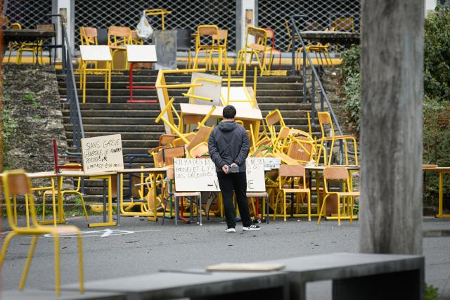 A student stands in front of the blocked entrance to a building at the University of Rennes 2, in Rennes on October 12, 2026. (Photo by Loic VENANCE / AFP)