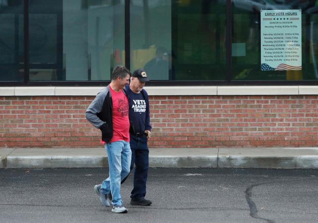 Voters exit the poling place after casting their votes in the 2026 US midterm election at the Summit County Board of elections in Akron, Ohio, on October 12, 2026. Americans voting in the November 3 midterm elections will decide who controls Congress for the final two years of Donald Trump's presidency, along with dozens of governorships and thousands of state offices. (Photo by David MAXWELL / AFP)