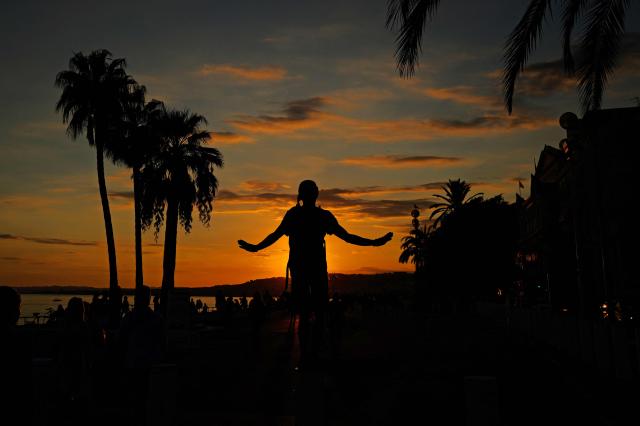A man gestures as he takes a stroll on the  "Promenade des Anglais", at the sunset, on the French riviera city of Nice, southern France, on October 12, 2026. (Photo by Valery HACHE / AFP)