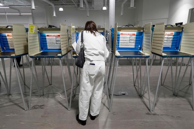 A voter fills out her ballot for the US midterm election at the Summit County Board of elections in Akron, Ohio, on October 12, 2026. Americans voting in the November 3 midterm elections will decide who controls Congress for the final two years of Donald Trump's presidency, along with dozens of governorships and thousands of state offices. (Photo by David MAXWELL / AFP)