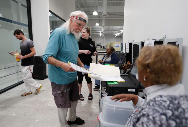 A voter casts his ballot in the US midterm election at the Summit County Board of elections in Akron, Ohio, on October 12, 2026. Americans voting in the November 3 midterm elections will decide who controls Congress for the final two years of Donald Trump's presidency, along with dozens of governorships and thousands of state offices. (Photo by David MAXWELL / AFP)
