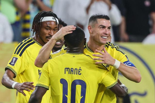 Nassr's Portuguese forward #07 Cristiano Ronaldo celebrates with Nassr's Senegalese Forward #10 Sadio Mane after scoring his team's second goal during the AFC Champions League group B football match between Al-Nassr and Neftchi Fergana at the Alawwal Park stadium in Riyadh on October 12, 2026. (Photo by Fayez NURELDINE / AFP)