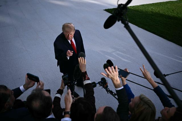 US President Donald Trump talks to the media before boarding Marine One as he departs from the South Lawn of the White House in Washington, DC, on October 12, 2026. President Trump is traveling to Youngstown, Ohio, to hold a campaign rally ahead of the midterm elections. (Photo by Brendan SMIALOWSKI / AFP)