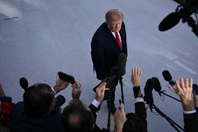 US President Donald Trump talks to the media before boarding Marine One as he departs from the South Lawn of the White House in Washington, DC, on October 12, 2026. President Trump is traveling to Youngstown, Ohio, to hold a campaign rally ahead of the midterm elections. (Photo by Brendan SMIALOWSKI / AFP)