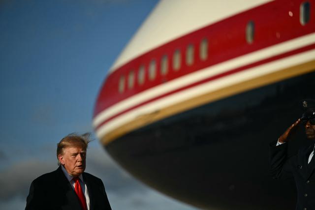 US President Donald Trump walks to board Air Force One at Joint Base Andrews, Maryland, on October 12, 2026. President Trump is traveling to Youngstown, Ohio, to hold a campaign rally ahead of the midterm elections. (Photo by Kent NISHIMURA / AFP)