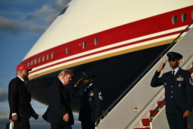 US President Donald Trump boards Air Force One with US boxer and influencer Jake Paul at Joint Base Andrews, Maryland, on October 12, 2026. President Trump is traveling to Youngstown, Ohio, to hold a campaign rally ahead of the midterm elections. (Photo by Kent NISHIMURA / AFP)