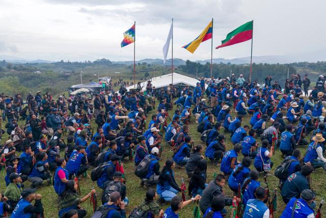 This aerial view shows Indigenous guards taking part in a training session during the Summit of the Indigenous People of Southwest Colombia in Caldono, Cauca department, Colombia, on October 12, 2026, as part of activities marking Indigenous Resistance Day, commemorating the resistance of Indigenous peoples since the arrival of Christopher Columbus in the Americas. (Photo by JOAQUIN SARMIENTO / AFP)
