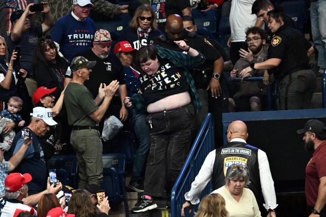A protester is removed from the venue while US President Donald Trump speaks during a campaign rally at the Covelli Centre in Youngstown, Ohio, on October 12, 2026. (Photo by Kent NISHIMURA / AFP)