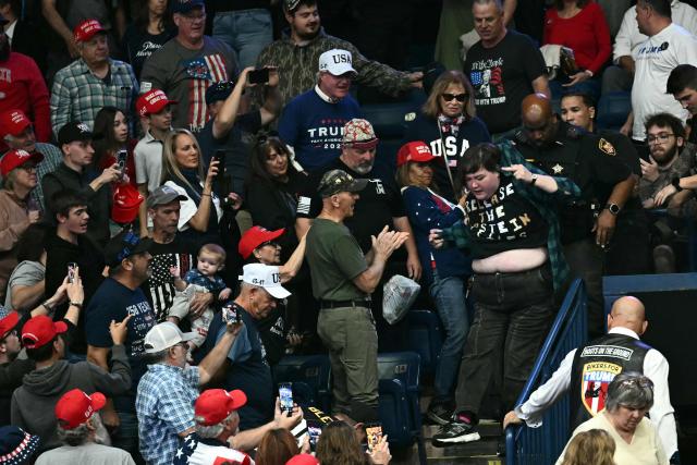 A protester is removed from the venue while US President Donald Trump speaks during a campaign rally at the Covelli Centre in Youngstown, Ohio, on October 12, 2026. (Photo by Kent NISHIMURA / AFP)