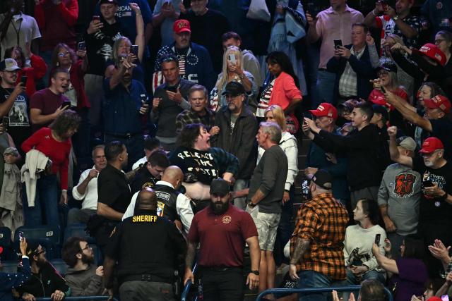 A protester is removed from the venue as US President Donald Trump speaks during a campaign rally at the Covelli Centre in Youngstown, Ohio, on October 12, 2026. (Photo by Kent NISHIMURA / AFP)