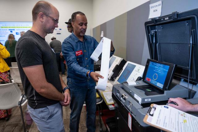 Volunteers attend voter machine training ahead of the midterm elections, in Charlotte, North Carolina, on October 12, 2026. Americans voting in the November 3 midterm elections will decide who controls Congress for the final two years of Donald Trump's presidency, along with dozens of governorships and thousands of state offices. (Photo by Amy Stewart / AFP)