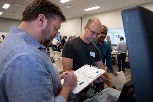 Volunteers attend voter machine training ahead of the midterm elections, in Charlotte, North Carolina, on October 12, 2026. Americans voting in the November 3 midterm elections will decide who controls Congress for the final two years of Donald Trump's presidency, along with dozens of governorships and thousands of state offices. (Photo by Amy Stewart / AFP)
