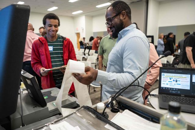 Volunteers attend voter machine training ahead of the midterm elections, in Charlotte, North Carolina, on October 12, 2026. Americans voting in the November 3 midterm elections will decide who controls Congress for the final two years of Donald Trump's presidency, along with dozens of governorships and thousands of state offices. (Photo by Amy Stewart / AFP)