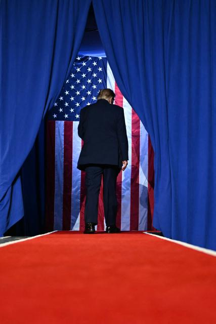 US President Donald Trump leaves the stage following a campaign rally at the Covelli Centre in Youngstown, Ohio, on October 12, 2026. (Photo by Kent NISHIMURA / AFP)