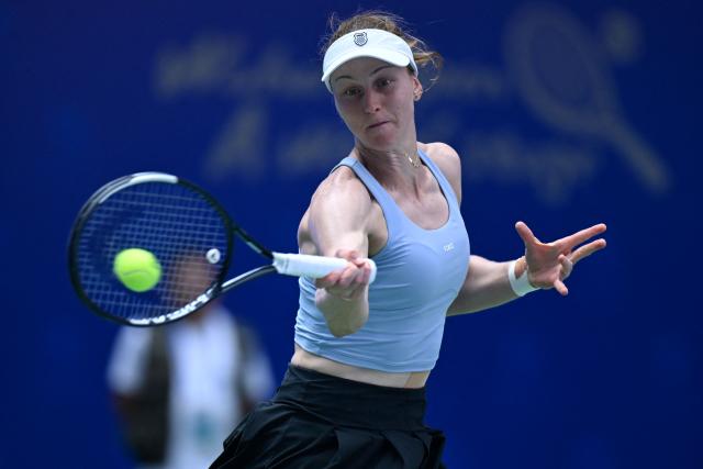 Russia's Liudmila Samsonova hits a return to Czech Republic's Katerina Siniakova during their women's singles match at the Wuhan Open tennis tournament in Wuhan, China's Hubei province on October 13, 2026. (Photo by WANG Zhao / AFP)