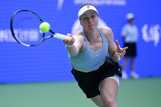 Russia's Liudmila Samsonova hits a return to Czech Republic's Katerina Siniakova during their women's singles match at the Wuhan Open tennis tournament in Wuhan, China's Hubei province on October 13, 2026. (Photo by WANG Zhao / AFP)