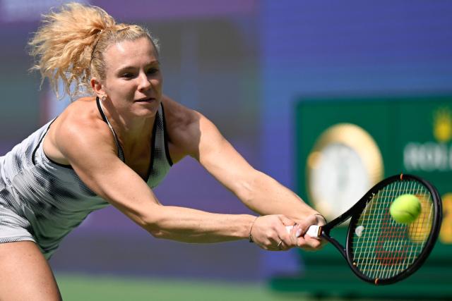 Czech Republic's Katerina Siniakova hits a return to Russia's Liudmila Samsonova during their women's singles match at the Wuhan Open tennis tournament in Wuhan, China's Hubei province on October 13, 2026. (Photo by WANG Zhao / AFP)