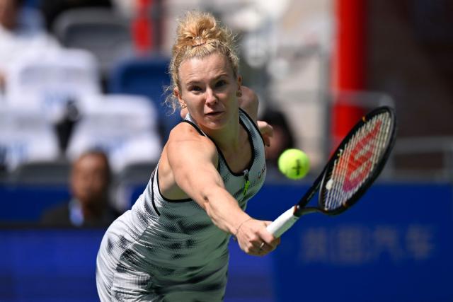 Czech Republic's Katerina Siniakova hits a return to Russia's Liudmila Samsonova during their women's singles match at the Wuhan Open tennis tournament in Wuhan, China's Hubei province on October 13, 2026. (Photo by WANG Zhao / AFP)