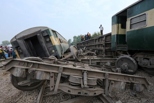 Rescue workers search for the victims following the derailment of passenger train Rehman Baba Express on the outskirts of Multan on October 13, 2026. (Photo by Shahid Saeed MIRZA / AFP)