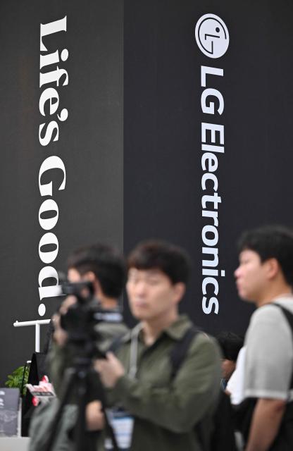Visitors walk past the LG Electronics booth during the Korea Electronics Show 2026 at the COEX convention and exhibition centre in Seoul on October 13, 2026. (Photo by Jung Yeon-je / AFP)