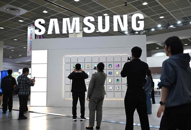 Visitors walk past the Samsung Electronics booth during the Korea Electronics Show 2026 at the COEX convention and exhibition centre in Seoul on October 13, 2026. (Photo by Jung Yeon-je / AFP)
