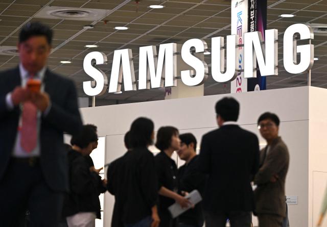 Visitors walk past the Samsung Electronics booth during the Korea Electronics Show 2026 at the COEX convention and exhibition centre in Seoul on October 13, 2026. (Photo by Jung Yeon-je / AFP)