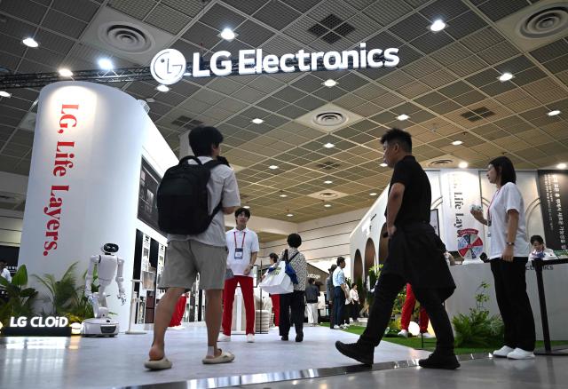 Visitors walk past the LG Electronics booth during the Korea Electronics Show 2026 at the COEX convention and exhibition centre in Seoul on October 13, 2026. (Photo by Jung Yeon-je / AFP)